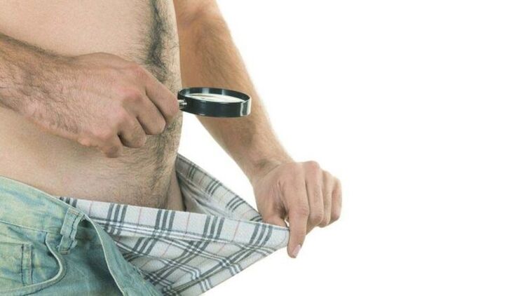 man looks at his underwear and thinks about penis enlargement with soda